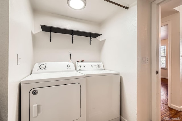 701 Harlan St Unit E59, Lakewood, CO 80214 - laundry room with laundry area, baseboards, wood finished floors, and washer and dryer