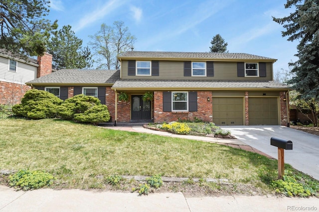traditional-style home with brick siding, an attached garage, concrete driveway, and a front yard