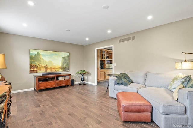 living room with recessed lighting, wood finished floors, and baseboards