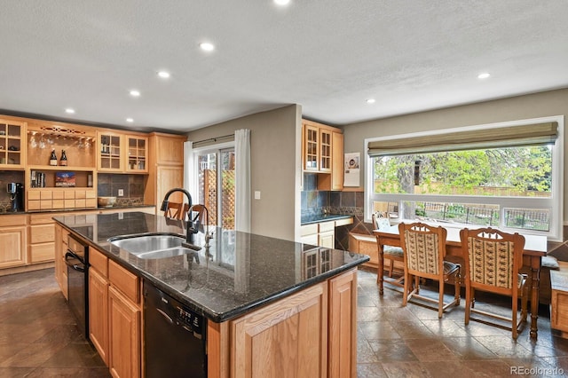 kitchen featuring a sink, black dishwasher, recessed lighting, a center island with sink, and backsplash