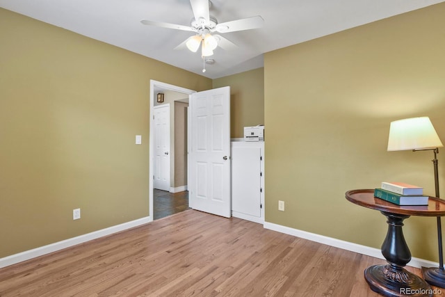 bedroom featuring baseboards, wood finished floors, and a ceiling fan