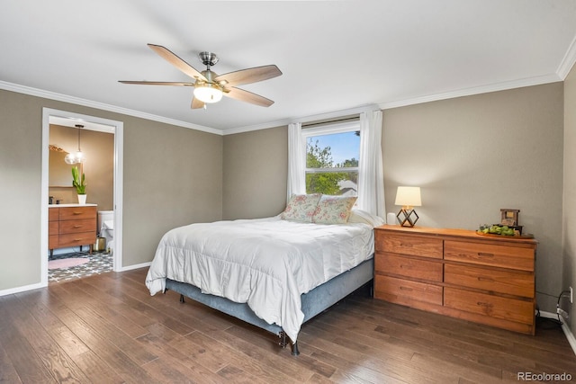 bedroom featuring dark wood-style flooring, ornamental molding, baseboards, and ensuite bath