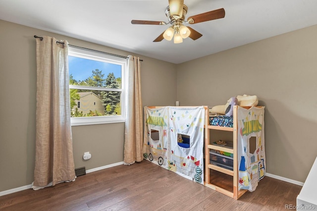 recreation room with wood finished floors, baseboards, and a ceiling fan