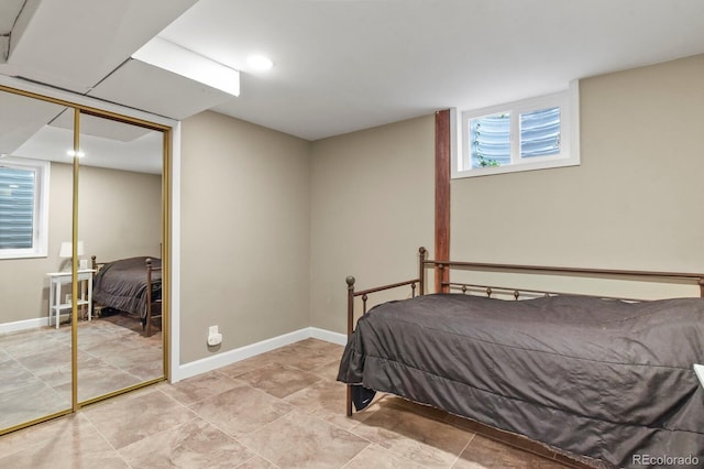 bedroom with a closet and baseboards