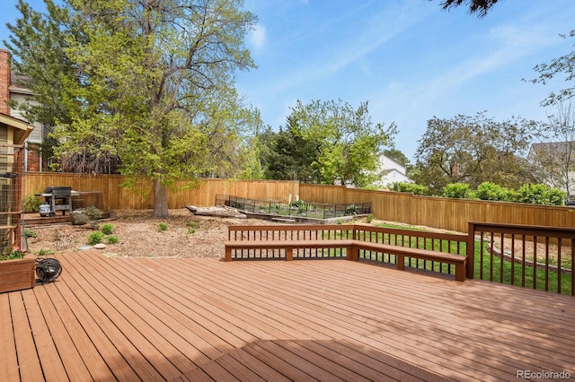 wooden terrace featuring a fenced backyard