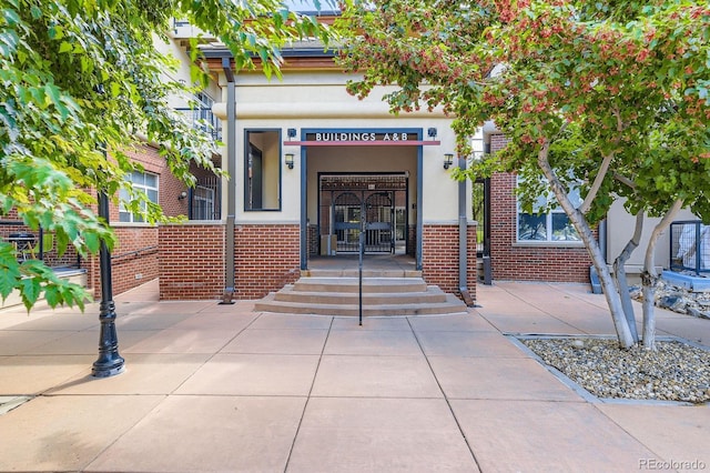 5677 S Park Pl Unit A308, Englewood, CO 80111 - property entrance featuring brick siding and stucco siding