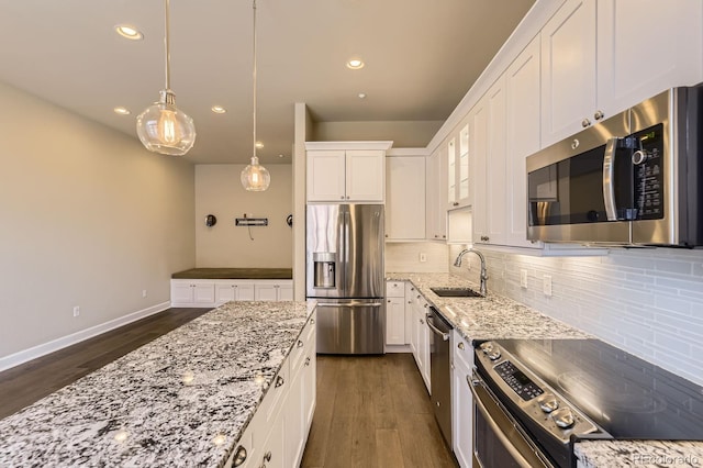 5677 S Park Pl Unit A308, Englewood, CO 80111 - kitchen with appliances with stainless steel finishes, dark wood-style floors, white cabinets, tasteful backsplash, and recessed lighting