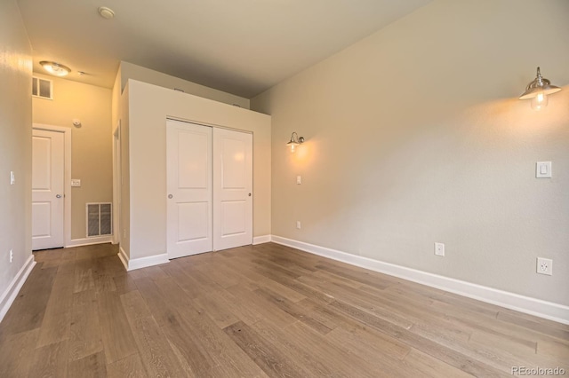 5677 S Park Pl Unit A308, Englewood, CO 80111 - unfurnished bedroom with wood finished floors and a closet