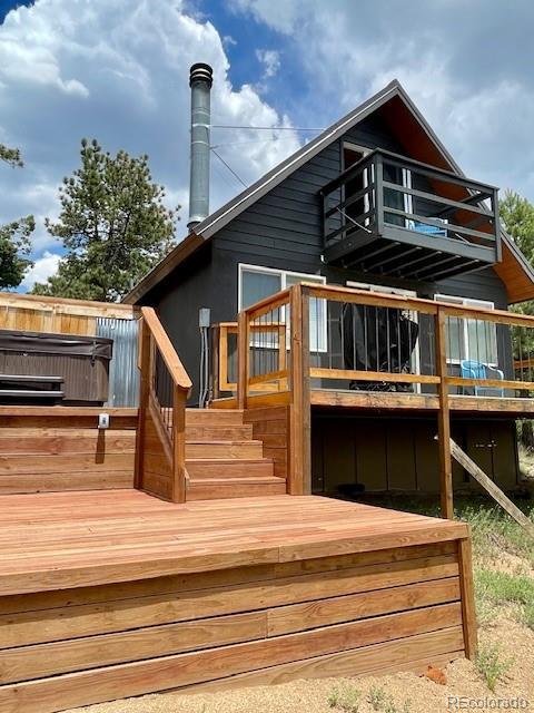 640 Ridgeway Dr, Cotopaxi, CO 81223 - rear view of house featuring a balcony, stairs, and a wooden deck