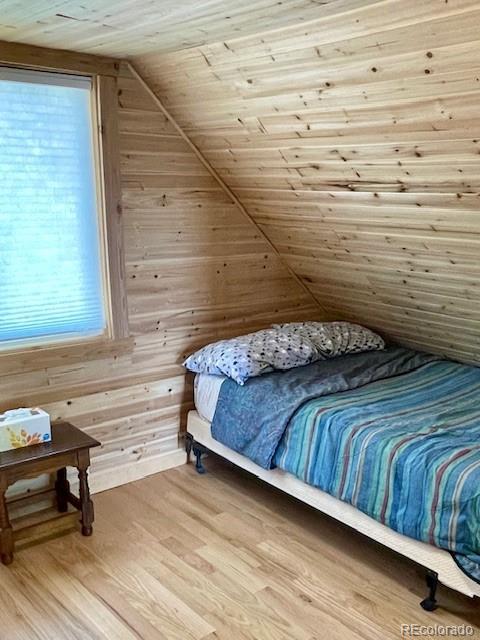 640 Ridgeway Dr, Cotopaxi, CO 81223 - bedroom with lofted ceiling, wooden ceiling, wood finished floors, and wood walls