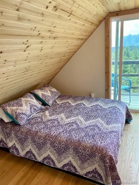 640 Ridgeway Dr, Cotopaxi, CO 81223 - bedroom with wood finished floors, wooden ceiling, lofted ceiling, and access to outside