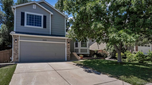 2602 Cove Creek Ct, Highlands Ranch, CO 80129 - view of front of property featuring concrete driveway, an attached garage, and brick siding