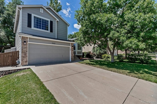 2602 Cove Creek Ct, Highlands Ranch, CO 80129 - view of front of property featuring driveway, a garage, and brick siding