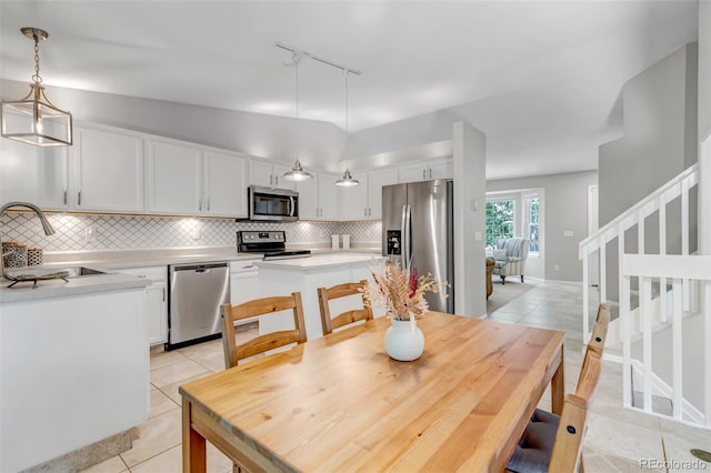 2602 Cove Creek Ct, Highlands Ranch, CO 80129 - dining area with rail lighting, light tile patterned floors, and stairway