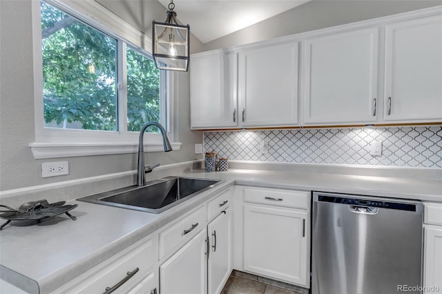 2602 Cove Creek Ct, Highlands Ranch, CO 80129 - kitchen featuring stainless steel dishwasher, tasteful backsplash, light countertops, white cabinets, and vaulted ceiling