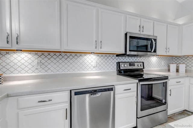 2602 Cove Creek Ct, Highlands Ranch, CO 80129 - kitchen with stainless steel appliances, light countertops, white cabinetry, and decorative backsplash