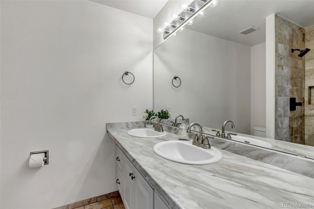 2602 Cove Creek Ct, Highlands Ranch, CO 80129 - bathroom with double vanity and a tile shower