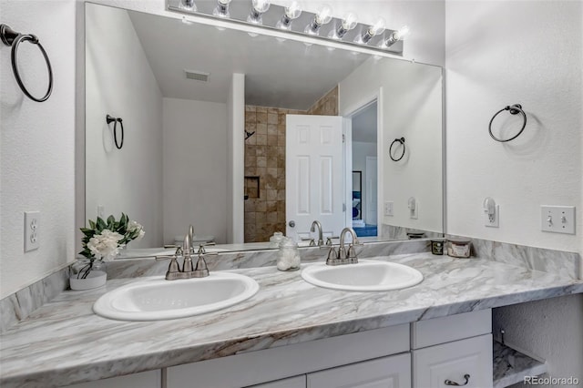 2602 Cove Creek Ct, Highlands Ranch, CO 80129 - full bathroom with double vanity and tiled shower