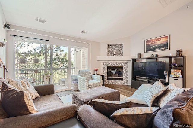 7409 S Alkire St Unit 304, Littleton, CO 80127 - living area featuring lofted ceiling, wood finished floors, and a fireplace