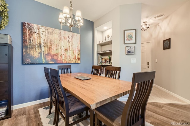 7409 S Alkire St Unit 304, Littleton, CO 80127 - dining space with a chandelier and wood finished floors