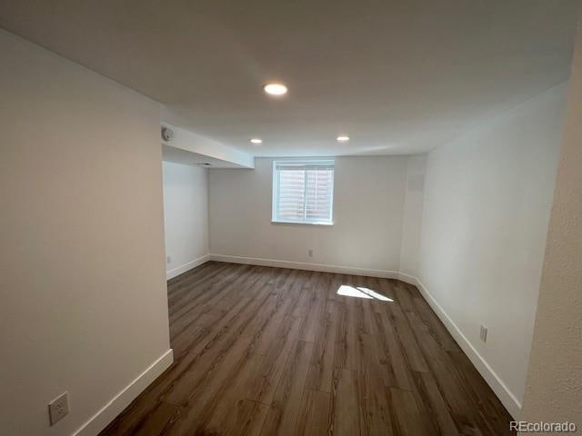 basement with dark hardwood / wood-style floors