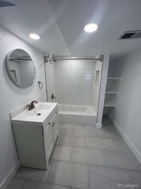 983 Xenon, Golden, CO 80401 - bathroom featuring marble look tile flooring, vanity, and bathtub / shower combination