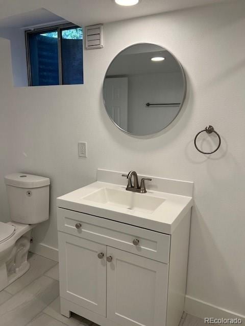 bathroom with vanity and toilet