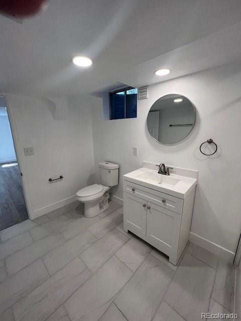 983 Xenon, Golden, CO 80401 - bathroom with marble finish flooring, vanity, and recessed lighting