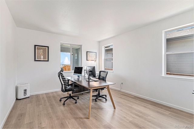 office space featuring light wood-style floors and baseboards