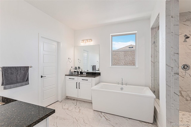 bathroom featuring a freestanding tub, vanity, marble finish floor, and a tile shower