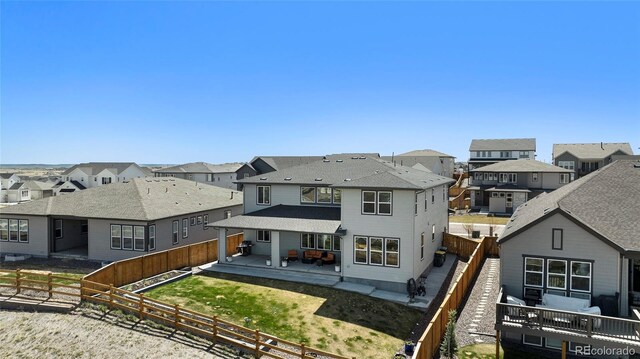 back of property featuring a residential view, a patio, and a fenced backyard