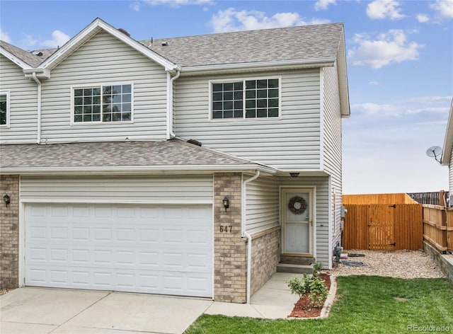 647 Berwick Ave, Firestone, CO 80520 - traditional-style home featuring concrete driveway, a garage, a shingled roof, a gate, and brick siding