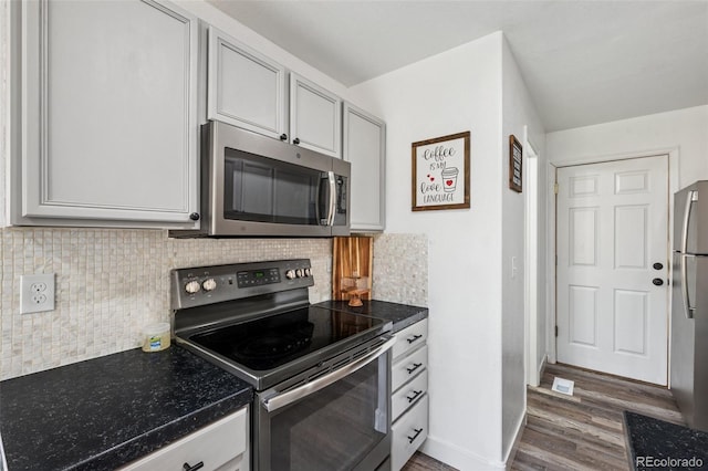 647 Berwick Ave, Firestone, CO 80520 - kitchen featuring stainless steel appliances, dark wood-type flooring, dark countertops, and tasteful backsplash