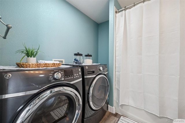 647 Berwick Ave, Firestone, CO 80520 - laundry room featuring washing machine and dryer, wood finished floors, and a textured wall