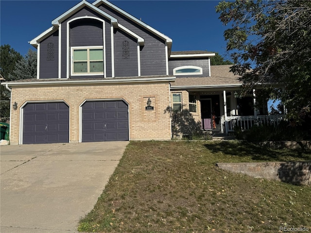 view of front of house featuring covered porch, a front yard, and a garage