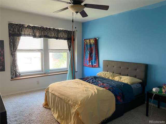 bedroom featuring ceiling fan and carpet