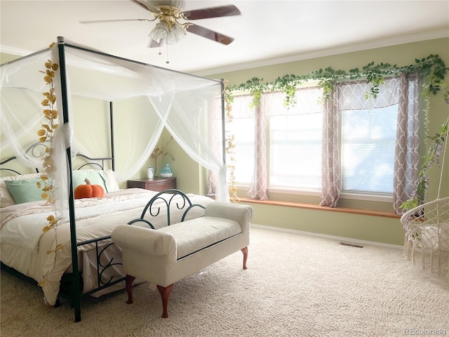 bedroom with ceiling fan, carpet, and ornamental molding