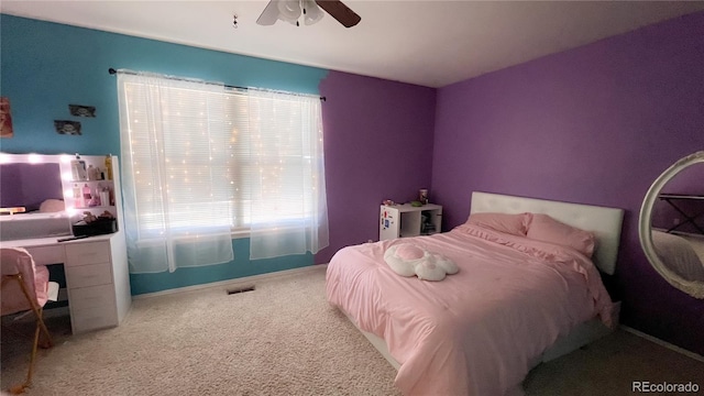 bedroom with ceiling fan and carpet floors