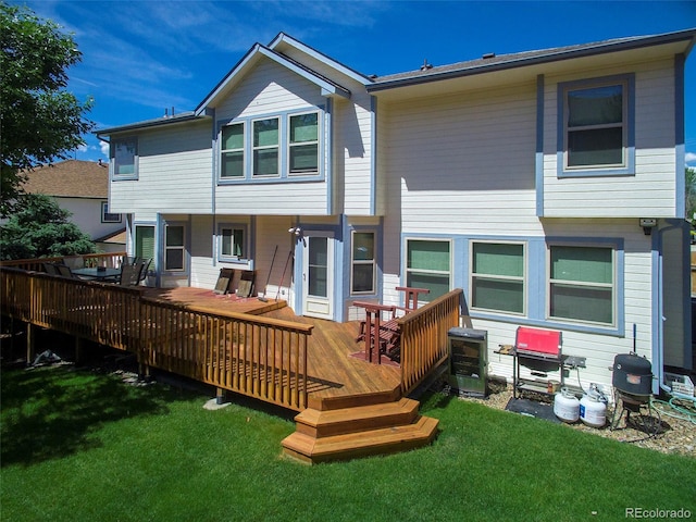 rear view of house featuring a yard and a deck