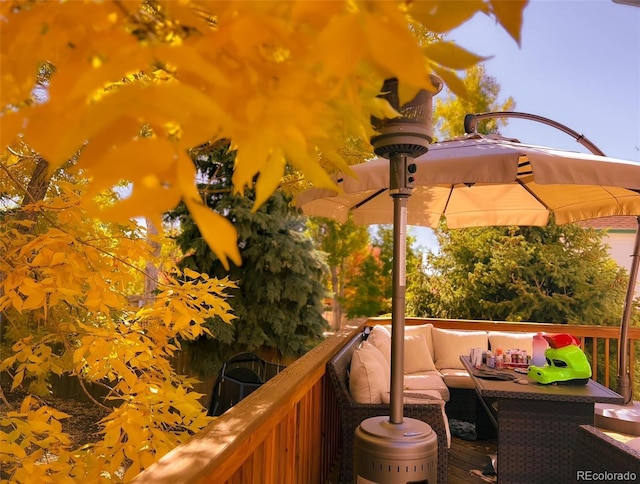 wooden balcony with an outdoor living space and a deck