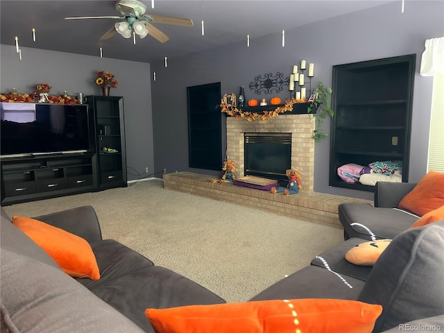 living room with carpet flooring, ceiling fan, and a fireplace