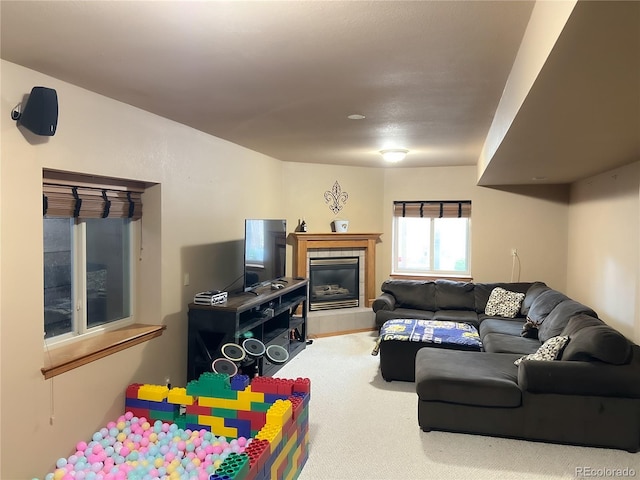 living room with a fireplace and carpet floors