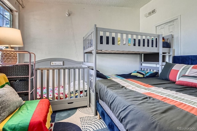 497 S Memphis Way Unit 17, Aurora, CO 80017 - carpeted bedroom with a textured ceiling
