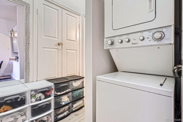 497 S Memphis Way Unit 17, Aurora, CO 80017 - washroom featuring stacked washer / drying machine and wood finished floors