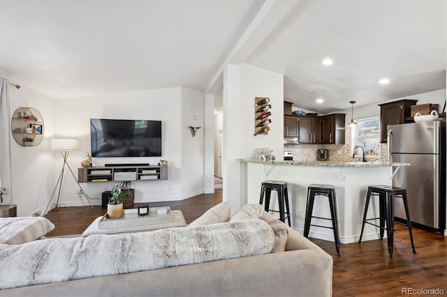 living room featuring sink, vaulted ceiling, and dark hardwood / wood-style flooring