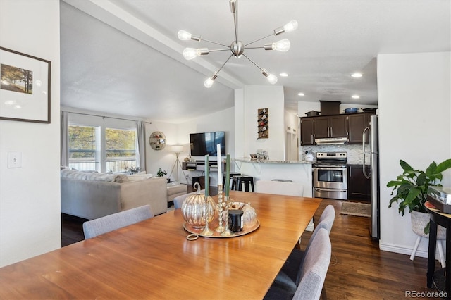 dining space with a notable chandelier, lofted ceiling, and dark hardwood / wood-style flooring