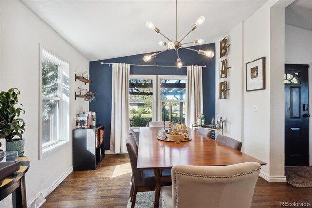 dining room with vaulted ceiling, plenty of natural light, and dark hardwood / wood-style flooring