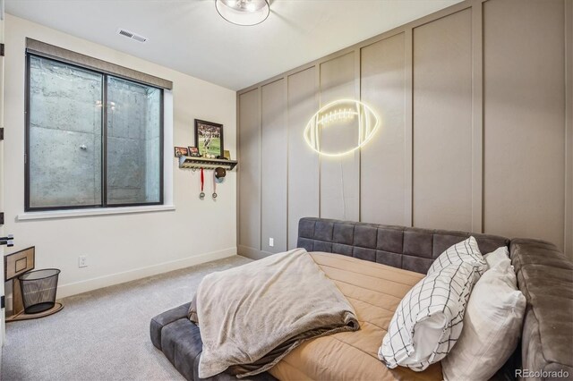 bedroom with baseboards, visible vents, and carpet flooring