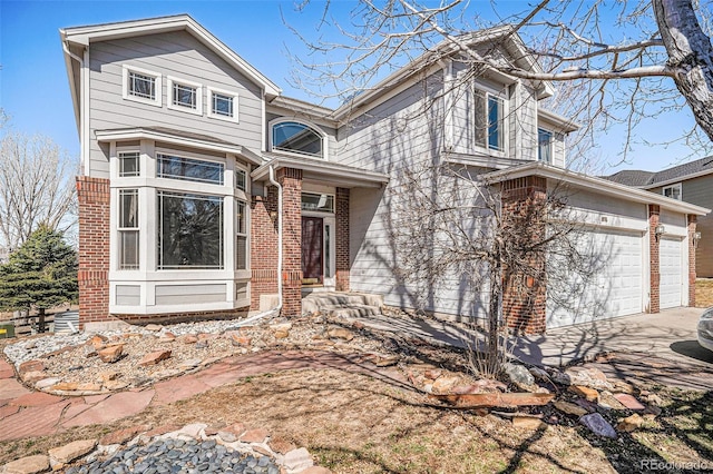 view of front of property featuring brick siding and concrete driveway