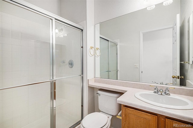 full bath featuring vanity, toilet, and a stall shower